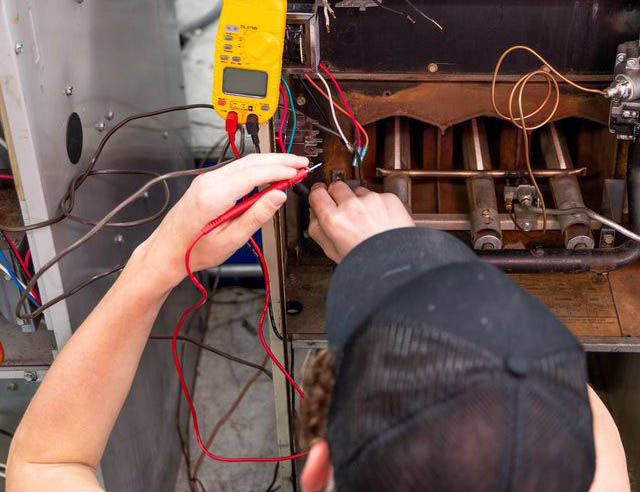 HVAC/R student testing the circuitry