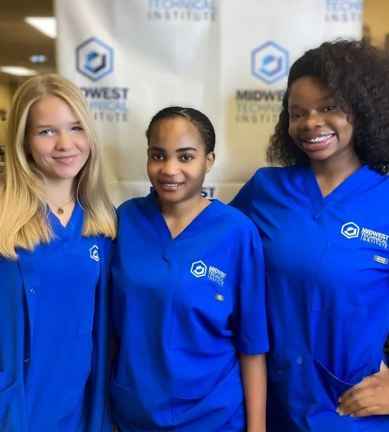 Students smiling in blue MTI polos